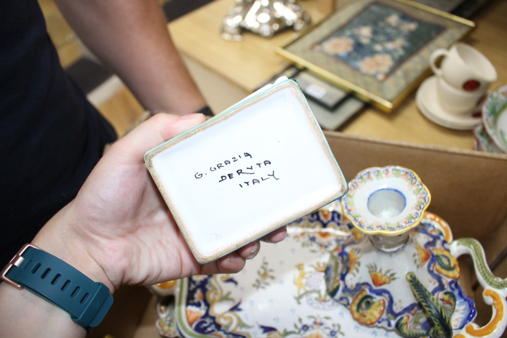 A collection of five St Malo faience dishes, a similar chamberstick, two inkwells, an unsigned oil lamp and a Deruta casket